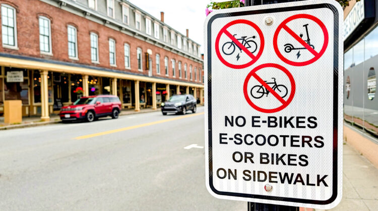 New signs on Main Street: "No E-bikes, E-Scooters or Bikes on Sidewalk"